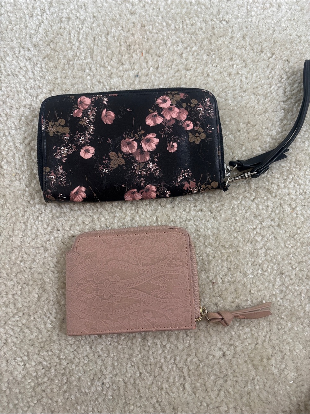 Small pink leather wallet and a floral wristlet